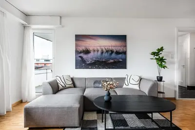 a living room with a couch and a table at SOHO 4A !Gratis Parken, Free Parking! in Kreuzlingen