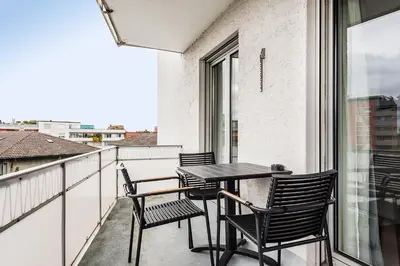 a balcony with a table and chairs and a window at SOHO 4A !Gratis Parken, Free Parking! in Kreuzlingen