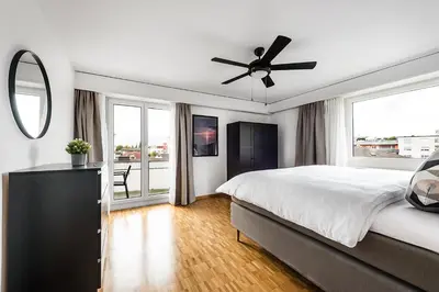 a bedroom with a bed and a ceiling fan at SOHO 4A !Gratis Parken, Free Parking! in Kreuzlingen