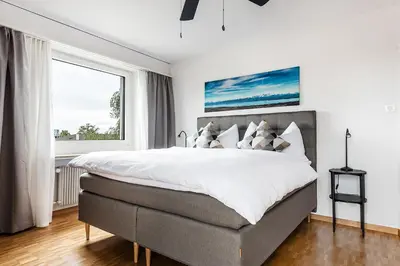 a bedroom with a large bed and a window at SOHO 4A !Gratis Parken, Free Parking! in Kreuzlingen