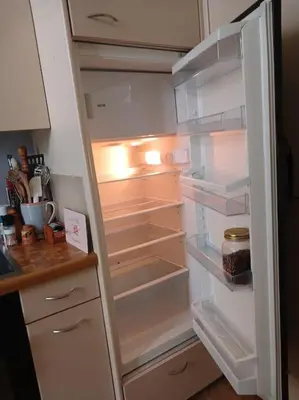 an empty refrigerator with its door open in a kitchen at Charmante Jugendstilwohnung mit Tiefengaragenplatz in St. Gallen