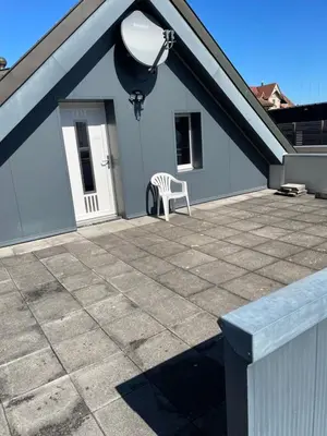 a white chair sitting on top of a roof at Ferienwohnung zentrale ruhige Lage auch gerne mit Kindern in Arbon