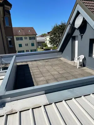 a flat roof with a patio on a house at Ferienwohnung zentrale ruhige Lage auch gerne mit Kindern in Arbon