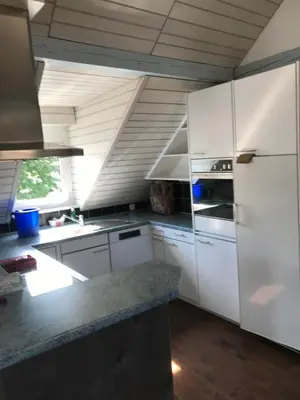 a kitchen with white cabinets and a white refrigerator at Ferienwohnung zentrale ruhige Lage auch gerne mit Kindern in Arbon