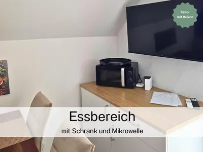 a microwave sitting on a table in a room at Ferienhausträume - Dachgeschoss Bodensee Apartment mit großer Dachterrasse in Kreuzlingen