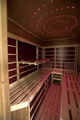 a large room with a tv and wooden floors at Chalet Wahida- Wellness Oase im Neckertal! in Sankt Peterzell