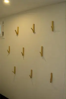 a wall with wooden arrows on a wall at Chalet Wahida- Wellness Oase im Neckertal! in Sankt Peterzell