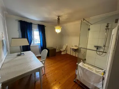 a bathroom with two sinks and a red door at VILLA Philipp Plein - Designervilla mit Pool & SPA in Amriswil