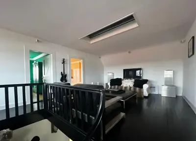 a room with two mirrors and a bench and windows at VILLA Philipp Plein - Designervilla mit Pool & SPA in Amriswil