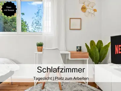 a white room with a desk and a window at Ferienhausträume - ebenerdiges Bodensee Apartment mit Garten und großer Terrasse mit Grill in Kreuzlingen