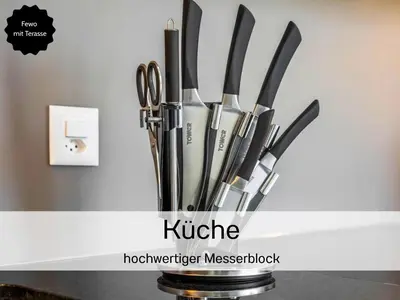 a group of knives in a holder on a counter at Ferienhausträume - ebenerdiges Bodensee Apartment mit Garten und großer Terrasse mit Grill in Kreuzlingen