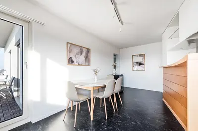 a dining room with a table and chairs at SOHO PENTHOUSE !Gratis Parken, Free Parking! in Kreuzlingen