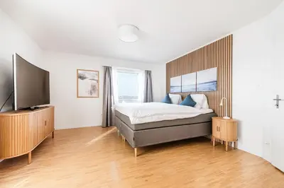 a bedroom with a bed and a flat screen tv at SOHO PENTHOUSE !Gratis Parken, Free Parking! in Kreuzlingen