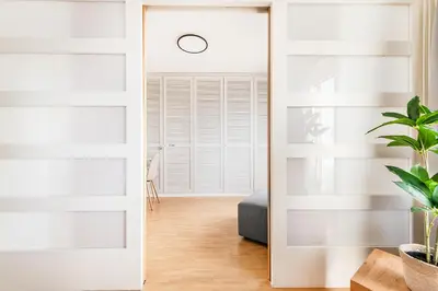 a sliding door in a living room with a mirror at SOHO PENTHOUSE !Gratis Parken, Free Parking! in Kreuzlingen