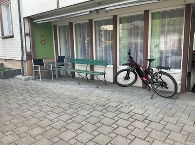 a bike parked next to a bench and a table at 01 - Gästehaus Erika - Hundwil - Appenzellerland in Hundwil