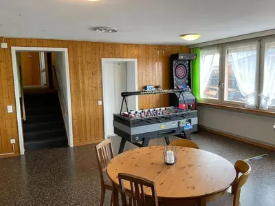 a room with a table and a table and a table and chairs at 03 - Gästehaus Erika - Hundwil - Appenzellerland in Hundwil