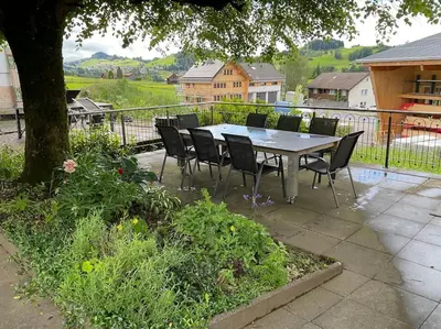 a table and chairs sitting on a patio at 08 - Gästehaus Erika - Hundwil - Appenzellerland in Hundwil