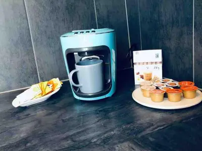 a coffee maker next to a plate of cupcakes at Klein aber Fein in Rorschach in Rorschach