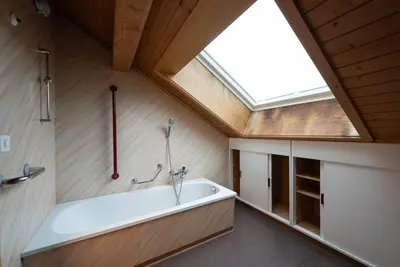 a bath tub in a bathroom with a skylight at 14 - Gästehaus Erika - Hundwil - Appenzellerland in Hundwil