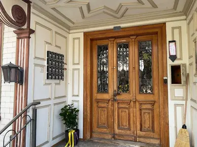 a wooden door with glass panels on a building at 16 - Gästehaus Erika - Hundwil - Appenzellerland in Hundwil