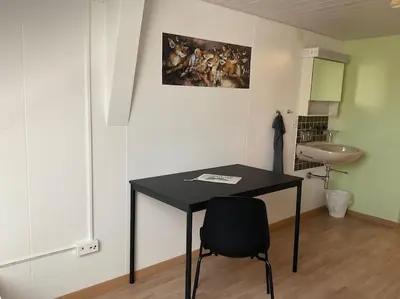 a black table and a sink in a room at 23 - Gästehaus Erika - Hundwil - Appenzellerland in Hundwil