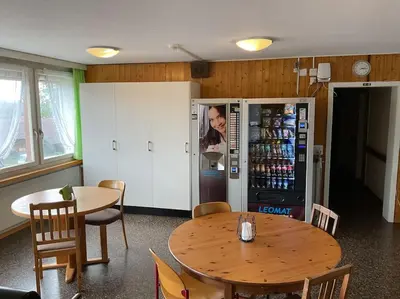 a dining room with a table and a refrigerator at 23 - Gästehaus Erika - Hundwil - Appenzellerland in Hundwil