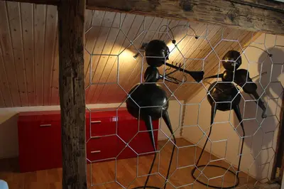 a room with two mannequins on a wall at Bauernhaus Hinterbühle in Wolfhalden