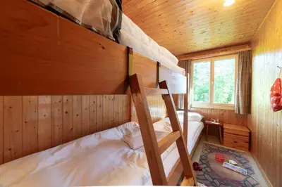 a bedroom with two bunk beds in a cabin at Dorea in Wildhaus