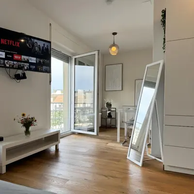a living room with a staircase and a mirror at Apartment im Zentrum St Gallen in St. Gallen