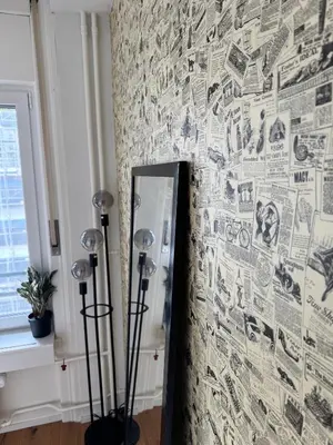 a room with a wall covered in drawings at Zentrales Apartment St Gallen an der Olma in St. Gallen