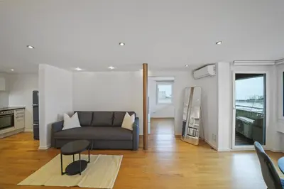a living room with a couch and a table at book2stay - Lakeview Apartment in Romanshorn