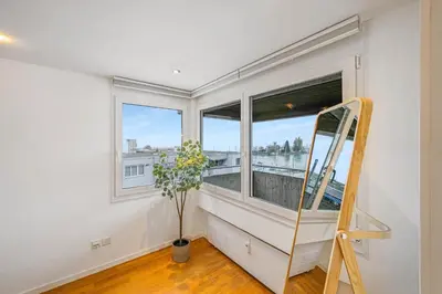 a room with a window and a ladder at book2stay - Lakeview Apartment in Romanshorn