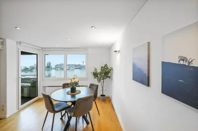a dining room with a table and chairs at book2stay - Lakeview Apartment in Romanshorn