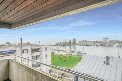 a view of a river from a balcony of a building at book2stay - Lakeview Apartment in Romanshorn
