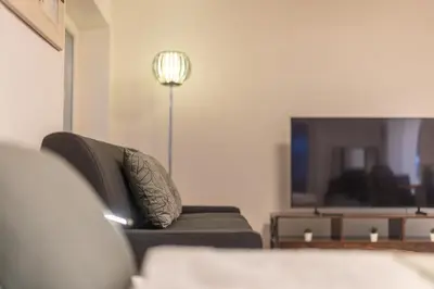a living room with a couch and a television at Jasminkas Host 2, Ruhig, City und Naturnah, Gratis Parkplatz und Balkon in St. Gallen