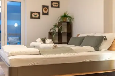 a white couch sitting in a living room at Jasminkas Host 2, Ruhig, City und Naturnah, Gratis Parkplatz und Balkon in St. Gallen
