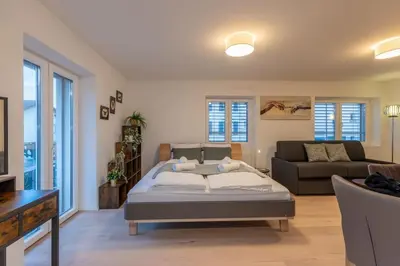 a living room with a bed and a couch at Jasminkas Host 2, Ruhig, City und Naturnah, Gratis Parkplatz und Balkon in St. Gallen
