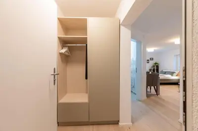 a room with a walk in closet and a dining room at Jasminkas Host 2, Ruhig, City und Naturnah, Gratis Parkplatz und Balkon in St. Gallen