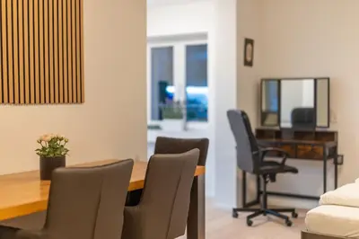 a living room with a dining room table and chairs at Jasminkas Host 2, Ruhig, City und Naturnah, Gratis Parkplatz und Balkon in St. Gallen