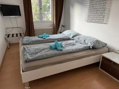 two stuffed animals sitting on a bed in a bedroom at Altstadt Gästehaus in Arbon
