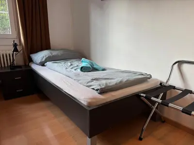 a bed in a room with a bed frame at Altstadt Gästehaus in Arbon