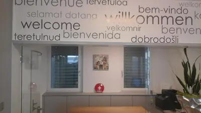 a wall with writing on it in a room at Hotel Flawil in Flawil