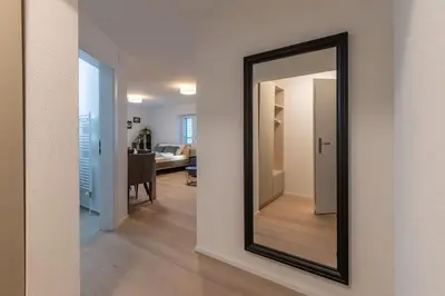a mirror on a wall in a living room at Jasminkas Host 1, Ruhig, Gratis Parkplatz Balkon & im 1, Stockwerk in St. Gallen