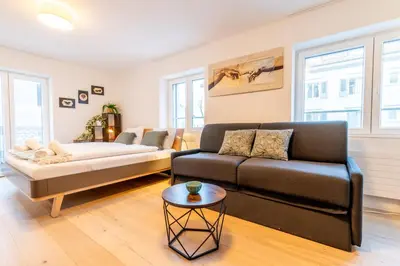 a living room with a couch and a table at Jasminkas Host 1, Ruhig, Gratis Parkplatz Balkon & im 1, Stockwerk in St. Gallen