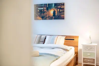 a bedroom with a bed with a poster on the wall at Nachhaltig Wohnen im 1, Stock, gratis Parkplatz! in St. Gallen