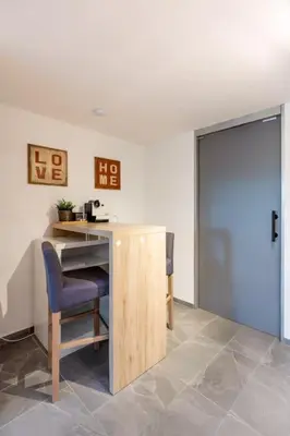 an office with a desk and a chair and a door at Nachhaltig Wohnen im 1, Stock, gratis Parkplatz! in St. Gallen