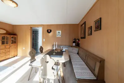 a kitchen with a table and chairs in a room at Fuechsle in Wildhaus