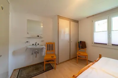 a bedroom with a large bed in a attic at Fuechsle in Wildhaus