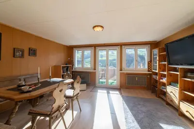 a kitchen with a table and a dining room at Fuechsle in Wildhaus