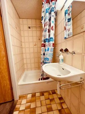 a bathroom with a sink and a bath tub at Private room with Bathroom and Lake View in Guest House in Heiden